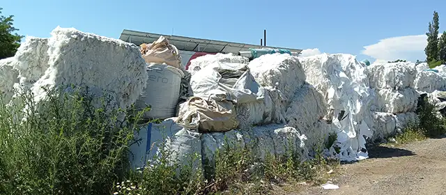 Stockpiled PP and PET packaging waste awaiting pyrolysis processing